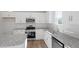 Modern kitchen with white cabinets, stainless steel appliances, granite countertops, and subway tile backsplash at 119 Grove Township Way, Angier, NC 27501