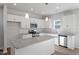 Stylish kitchen features white cabinets, granite countertops, stainless steel appliances, and a central island at 119 Grove Township Way, Angier, NC 27501