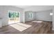 Bright living room with hardwood floors, access to deck, and plenty of natural light from multiple windows at 119 Grove Township Way, Angier, NC 27501