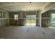 Large room featuring primed walls, ceilings, framing elements and a sliding glass doors at 119 Grove Township Way, Angier, NC 27501