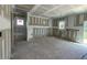 Spacious room featuring primed walls, ceilings, framing elements and large sliding glass door at 119 Grove Township Way, Angier, NC 27501