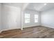 Bright living room featuring laminate floors, neutral walls, and natural light from two windows at 119 Grove Township Way, Angier, NC 27501