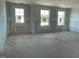 Bright room featuring primed walls, ceilings, framing elements and large windows at 119 Grove Township Way, Angier, NC 27501