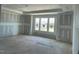 Unfinished living room with large windows providing ample natural light and drywall ready for paint at 119 Grove Township Way, Angier, NC 27501