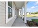 Covered side porch with views of neighboring homes and landscaping at 119 Grove Township Way, Angier, NC 27501