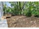 Spacious backyard with mature trees and a new wooden deck at 1521 Chapel Hill Rd, Durham, NC 27701