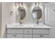 Bathroom boasts double vanity with marble countertop and modern lighting and fixtures at 1521 Chapel Hill Rd, Durham, NC 27701