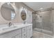 Bathroom boasts double vanity with marble countertop, modern lighting, and shower at 1521 Chapel Hill Rd, Durham, NC 27701