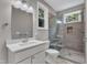 Stylish bathroom with modern vanity, toilet, and walk-in glass shower with gray tile surround at 1521 Chapel Hill Rd, Durham, NC 27701