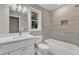 Modern bathroom with white vanity, marble countertop, and tiled shower-tub combination at 1521 Chapel Hill Rd, Durham, NC 27701