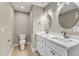 Bathroom boasts double vanity with marble countertop and modern fixtures, next to toilet at 1521 Chapel Hill Rd, Durham, NC 27701