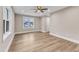 Bright bedroom features hardwood floors, a ceiling fan, and a window letting in natural light at 1521 Chapel Hill Rd, Durham, NC 27701