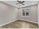 Bedroom features hardwood floors, a ceiling fan, and a window at 1521 Chapel Hill Rd, Durham, NC 27701