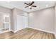 Bright bedroom features hardwood floors, a ceiling fan, closet and entry to the bathroom at 1521 Chapel Hill Rd, Durham, NC 27701