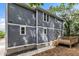 Exterior view of house features a wooden deck and newly-installed gray siding at 1521 Chapel Hill Rd, Durham, NC 27701