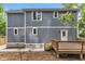 Rear exterior view of house features a wooden deck and newly-installed gray siding at 1521 Chapel Hill Rd, Durham, NC 27701