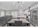 Open floor plan boasts a spacious living room, dining area, and kitchen with stainless steel appliances at 1521 Chapel Hill Rd, Durham, NC 27701