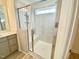 Modern bathroom featuring walk-in shower with glass door, tiled walls, and hardwood floors at 169 Steel Springs Lane Rd # 17, Angier, NC 27501