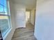 Bright entryway featuring wood-look flooring, fresh white trim, and a view into the kitchen at 169 Steel Springs Lane Rd # 17, Angier, NC 27501