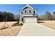 Charming two-story home featuring a two-car garage, gray siding and stone accents, and neatly landscaped front yard at 169 Steel Springs Lane Rd # 17, Angier, NC 27501