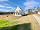 Beautiful two-story home with covered porch, surrounded by a newly landscaped yard on a sunny day at 169 Steel Springs Lane Rd # 17, Angier, NC 27501