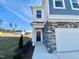 Stylish home showcasing a covered entryway, stone accents, and a manicured lawn at 169 Steel Springs Lane Rd # 17, Angier, NC 27501