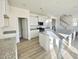 Modern kitchen featuring white cabinets, granite countertops, stainless appliances, and an island with a sink at 169 Steel Springs Lane Rd # 17, Angier, NC 27501