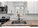 Close-up of the modern kitchen sink with granite countertops and new fixtures at 1804 Beverly Rd, Rocky Mount, NC 27801