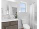 Bright bathroom featuring a gray vanity, white toilet, and shower with a neutral-colored curtain at 185 Horseshoe Pl # 54, Angier, NC 27501