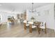 Elegant dining area with modern chandelier, table setting, and an open view to the kitchen at 185 Horseshoe Pl # 54, Angier, NC 27501