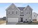 Charming two-story home with a classic design, showcasing a well-manicured lawn and an attached two-car garage at 185 Horseshoe Pl # 54, Angier, NC 27501