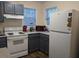 Updated kitchen featuring modern appliances including white refrigerator and stove, and gray cabinets at 1911 Wolftech Ln # 303, Raleigh, NC 27603