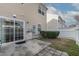 Backyard with a sliding glass door to the house and a small patio at 1952 Grassy Banks Dr, Raleigh, NC 27610