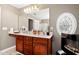 Bathroom with double vanity, granite counters, large mirror, and oval window feature at 1952 Grassy Banks Dr, Raleigh, NC 27610