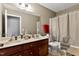 Bathroom with double sink vanity, toilet, and shower with curtain at 1952 Grassy Banks Dr, Raleigh, NC 27610