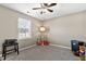 Cozy bedroom with neutral walls, window, and a ceiling fan at 1952 Grassy Banks Dr, Raleigh, NC 27610