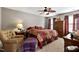 A primary bedroom features a ceiling fan, a large bed, and an armchair at 1952 Grassy Banks Dr, Raleigh, NC 27610