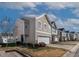 Attractive beige two-story home with a two-car garage and well-maintained landscaping at 1952 Grassy Banks Dr, Raleigh, NC 27610