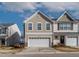 Inviting two-story home featuring a two-car garage and manicured landscaping at 1952 Grassy Banks Dr, Raleigh, NC 27610