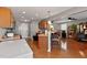 Open kitchen featuring hardwood floors, bar-style seating, and modern appliances at 1952 Grassy Banks Dr, Raleigh, NC 27610
