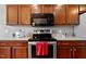 Close up of kitchen features stainless steel appliances and dark wood cabinets at 1952 Grassy Banks Dr, Raleigh, NC 27610