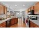 Bright kitchen with hardwood floors, stainless appliances and backyard views from sliding glass door at 1952 Grassy Banks Dr, Raleigh, NC 27610