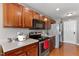 Close up of kitchen features stainless steel appliances and dark wood cabinets at 1952 Grassy Banks Dr, Raleigh, NC 27610