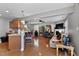 Spacious open concept living room with hardwood floors, a bar, and access to the kitchen at 1952 Grassy Banks Dr, Raleigh, NC 27610