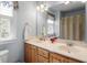 Well-lit bathroom features a double vanity, large mirror, neutral paint and fixtures, and a window at 2030 Lonesome Dove Dr, Franklinton, NC 27525