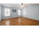 This spacious bedroom boasts pristine hardwood floors, neutral paint, large windows, and a ceiling fan at 2030 Lonesome Dove Dr, Franklinton, NC 27525