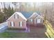 Lovely brick home with a well-manicured front lawn and symmetrical design, enhancing its curb appeal at 2030 Lonesome Dove Dr, Franklinton, NC 27525