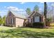 Brick house exterior with manicured shrubs, bright green grass, and architectural details at 2030 Lonesome Dove Dr, Franklinton, NC 27525