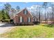 Well-maintained brick home with green lawn, mature trees, and ample curb appeal at 2030 Lonesome Dove Dr, Franklinton, NC 27525