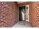 Close-up of brick facade and modern front door with decorative glass and welcome mat at 2030 Lonesome Dove Dr, Franklinton, NC 27525